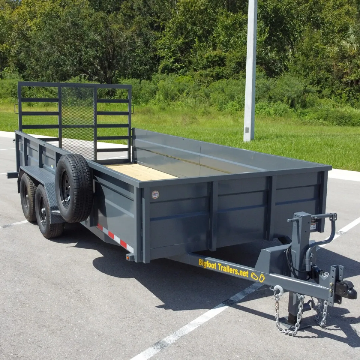 Heavy-duty utility trailer with high sides and wood deck